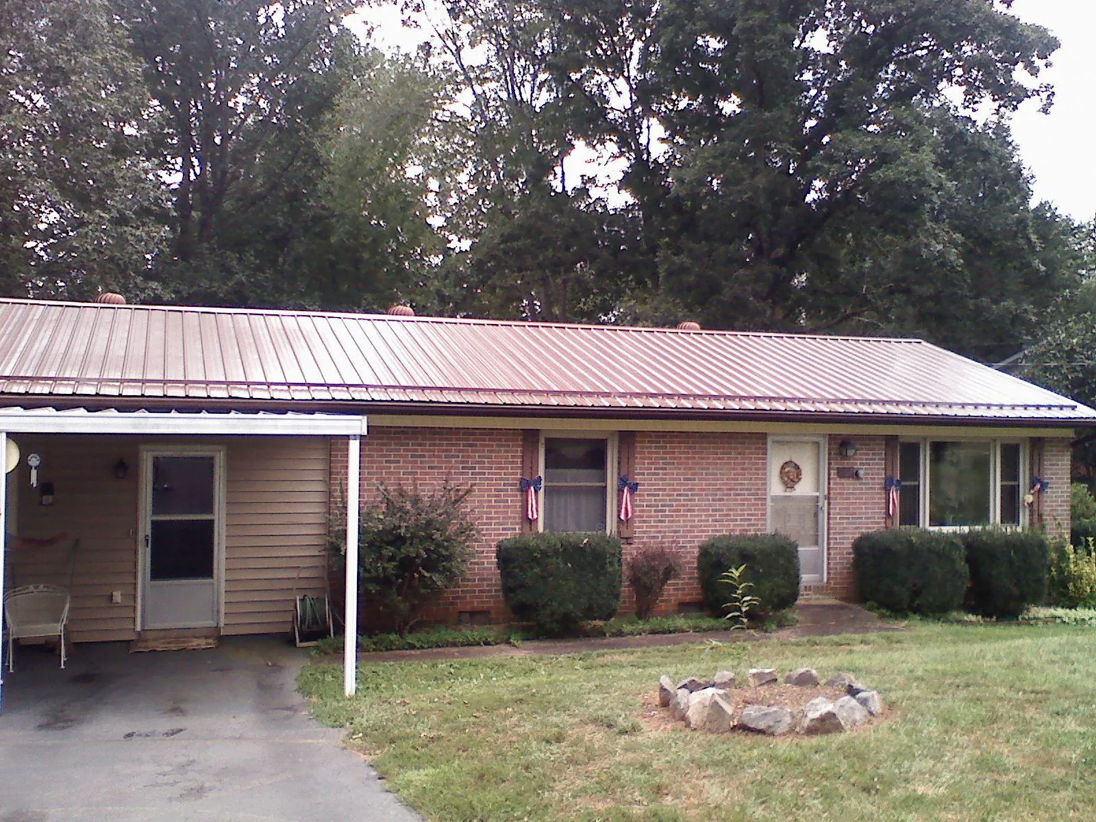 Bronze metal roof and carport on a brick ranch home — Roof Repair work by our crew in Mill Valley
